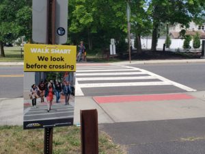 A bicyclist waits to cross the street